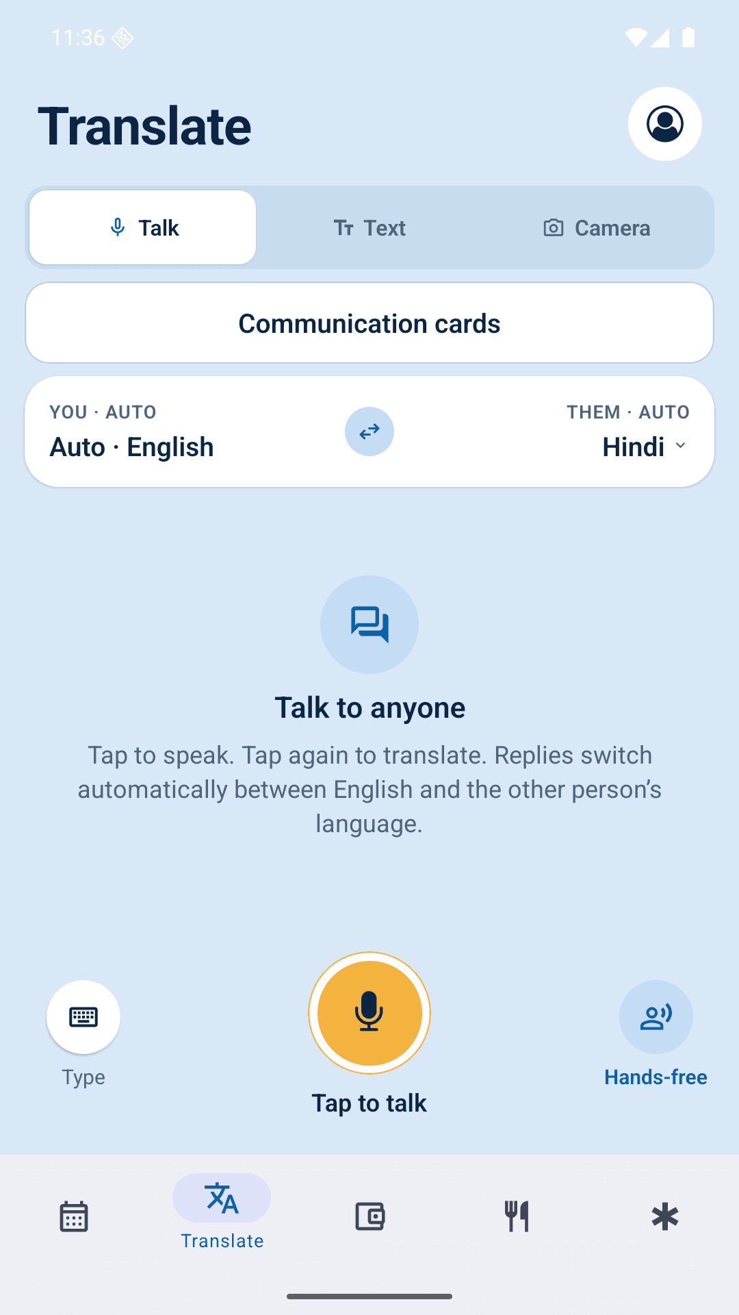The Roamie Translate screen in Talk mode, set to English and Hindi, with a large tap-to-talk button and a hands-free option
